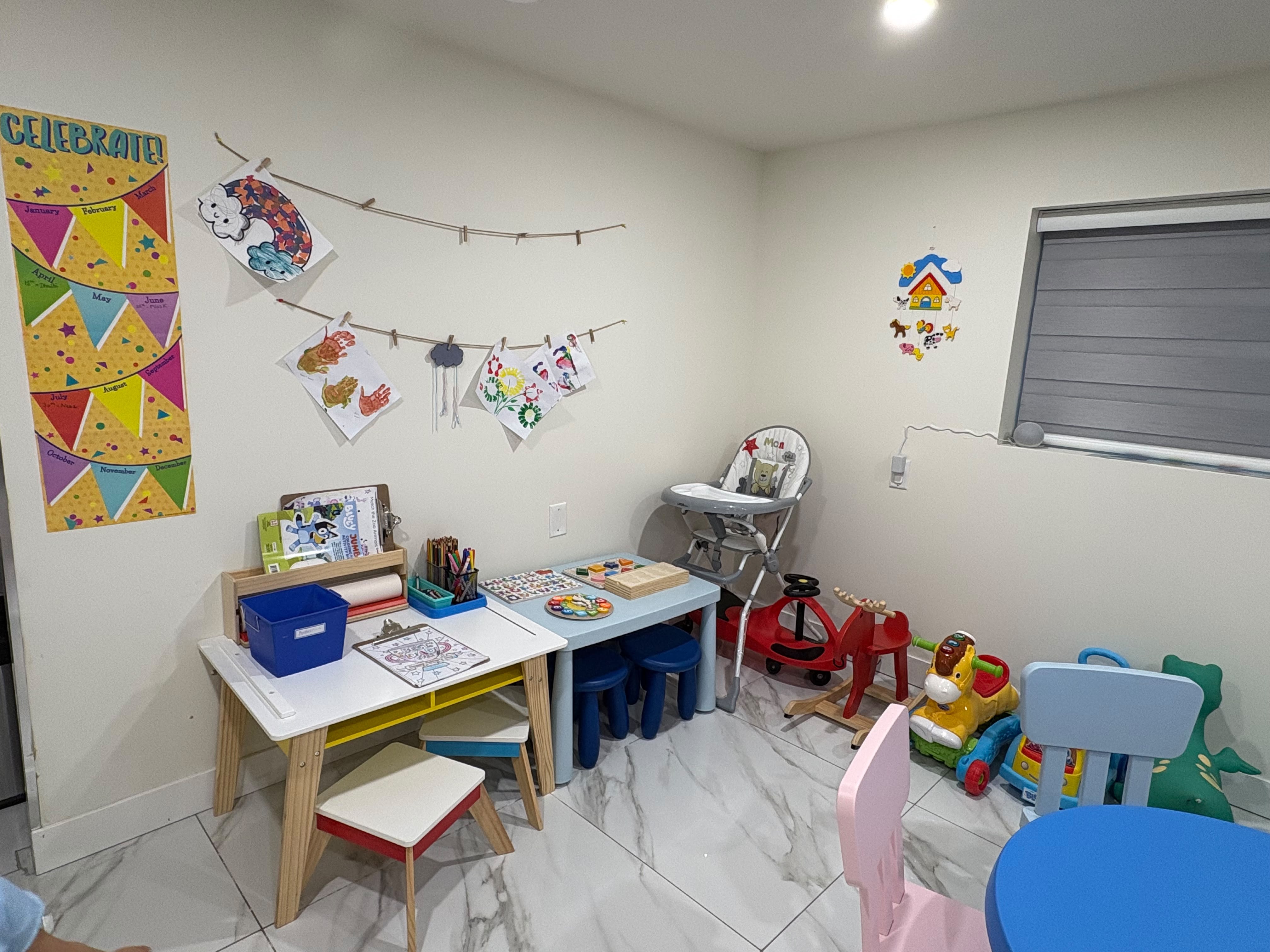 Children's art displayed in a creative activity room