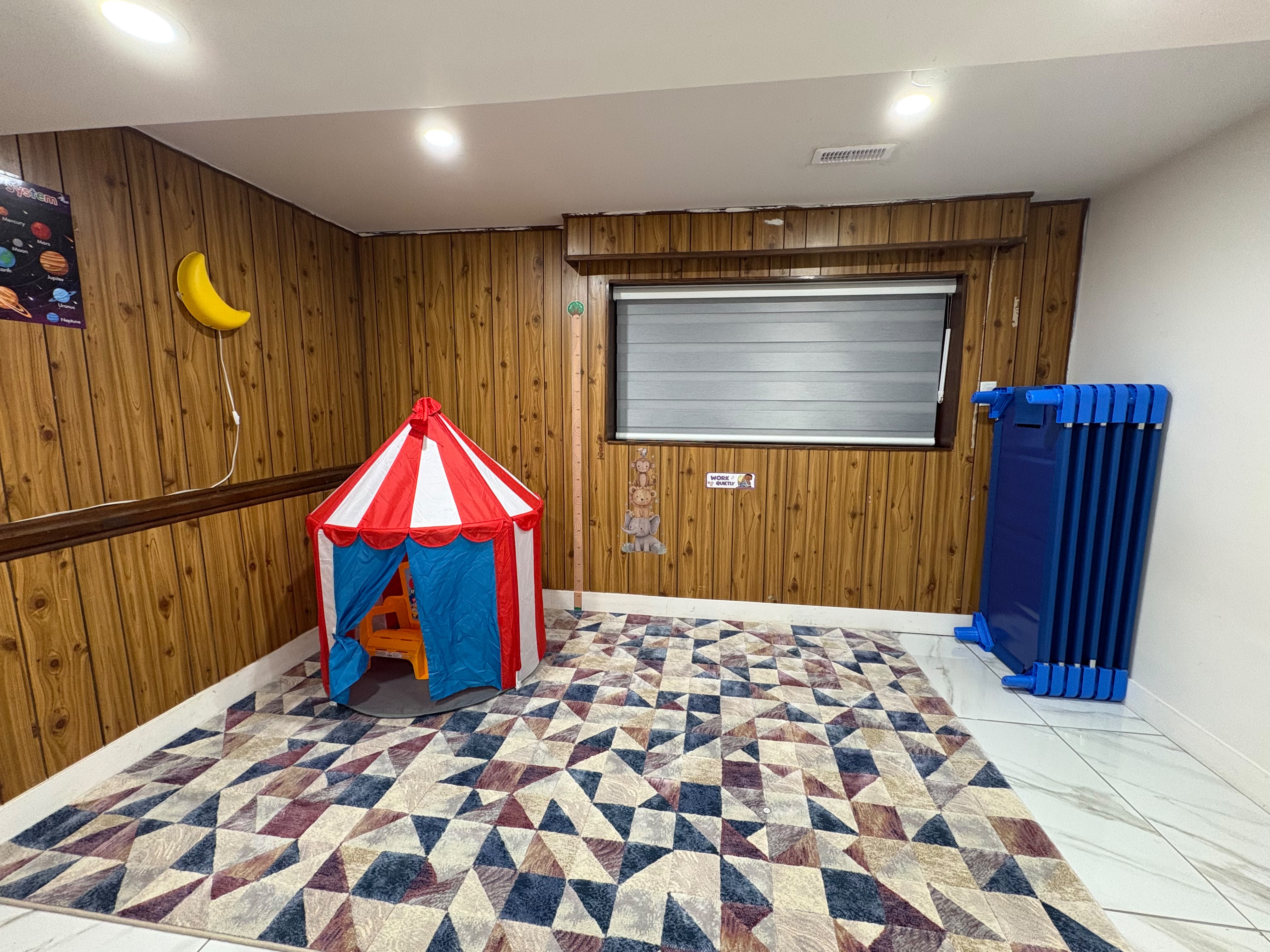 Quiet rest and movement room with a play tent and soft floor mats